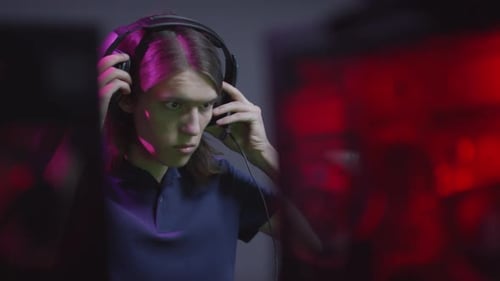 Young Adult Putting on Headphones with Microphone