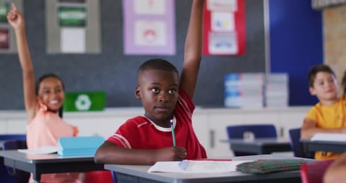 Enthusiastic Children Raising Hands in Classroom