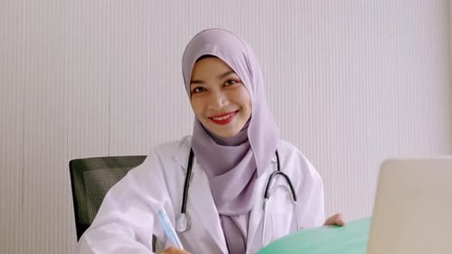 Portrait of Muslim doctor sitting in clinic office