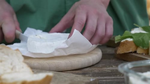 Preparing Gourmet Cheese and Spinach Sandwich on Wood