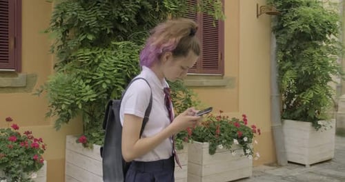 Young Woman Using Smartphone in Urban Setting