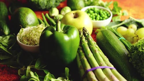 Fresh Green Vegetables and Fruits Assortment Placed on a Rusty Metal