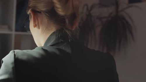 Tired Blonde Businesswoman Working in the Evening at Office Desk