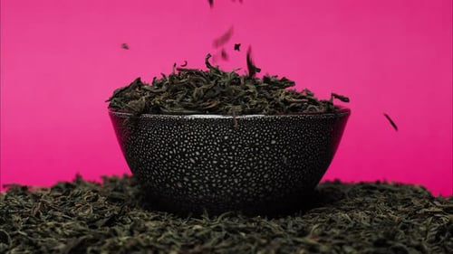 Tea Leaves Pouring into Bowl