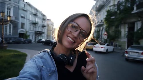 Smiling Young Woman on City Street