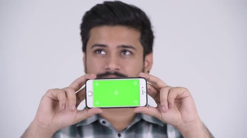 Adult Holding Phone with Green Screen Close Up