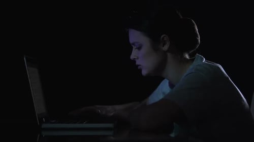 Woman Working Late at Night on Laptop