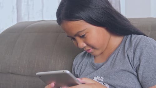 Asian Girl Playing With Tablet