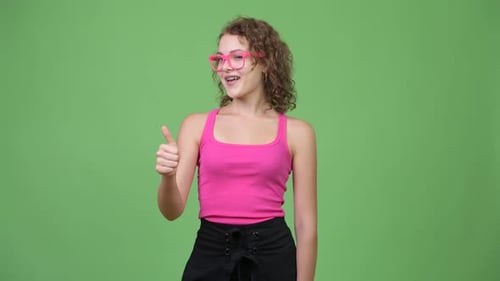 Young Woman Gives Thumbs Up on Green Screen