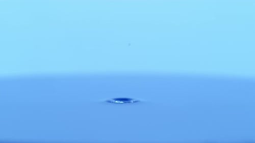 Water Droplet Ripples on a Blue Surface