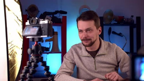 Blogger in Video Studio Turns on Camera for Recording and Shoots Video Blog