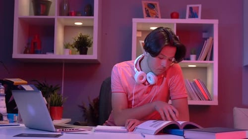 Student Studies at Desk with Laptop at Night