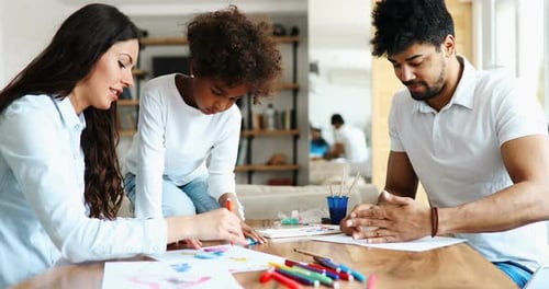 Family Drawing Together at Table Inside Home