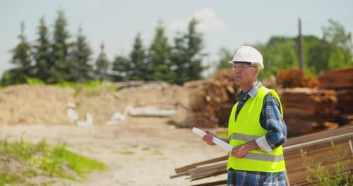 Inspector with Plans on a Construction Site