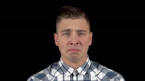 The Young Man Is Crying. Emotional Man Crying on a Black Background Closeup