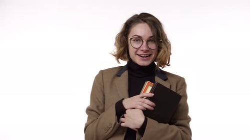 Woman with Notebook Posing Indoors Smiling