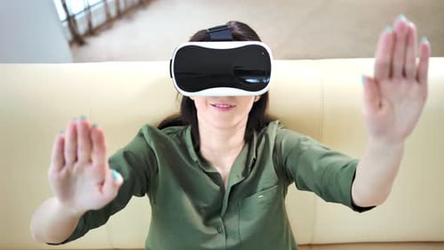 Woman Using Virtual Reality Headset on Couch