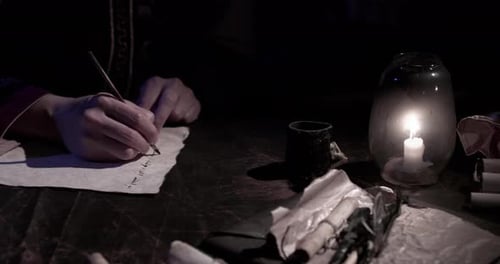 Writing Letter by Candlelight in Historical Setting