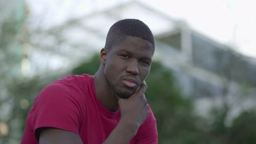 Thoughtful Young Man Looking at Camera Outdoors