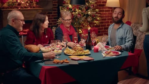 Family Celebrates Christmas With Dinner and Photographs