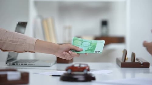 Woman Giving Euro Money to Car Dealer, Down Payment on Latest Electric Vehicle