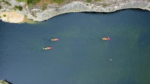 Aerial drone view following kayaks.