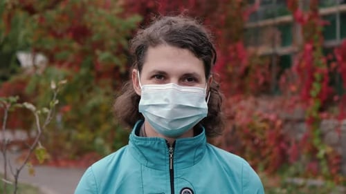 Woman Wearing Surgical Mask Outside in Autumn