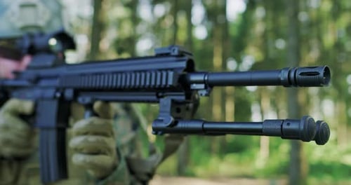 Soliders Aiming Assault Rifle and Protecting Military Base