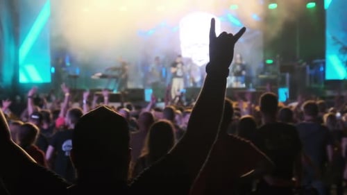 Crowd of Fans at Live Rock Concert Raise Hands and Dance. Slow Motion 240 Fps