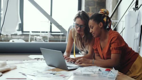 Two Diverse Female Designers Working and Posing for Camera in Atelier