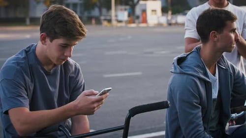 Young Men Gather in Urban Setting with Bikes