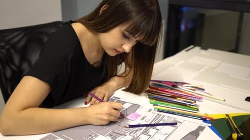 Woman Coloring Architectural Drawing at Workplace