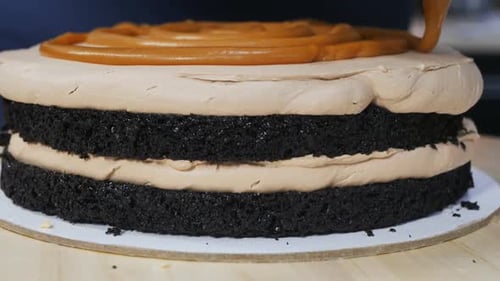 Caramel Drizzle Being Poured on Decadent Layer Cake