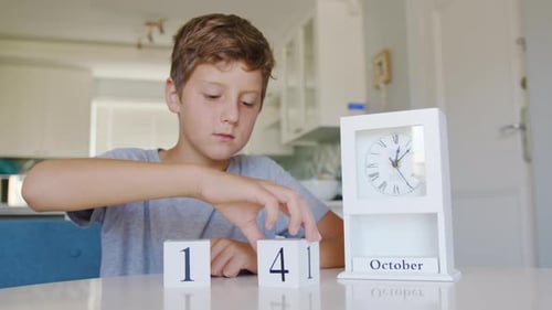 Boy Flips Handmade Wood Cubes with Dateday Month Halloween Holiday