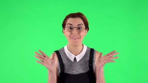 Portrait of Funny Girl in Round Glasses with Wow Face Expression. Green Screen