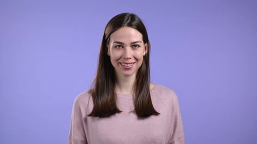 Portrait of Woman Over Violet Studio Background