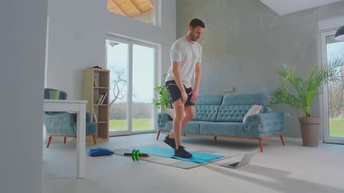 Young Adult Male Doing Lunges at Home