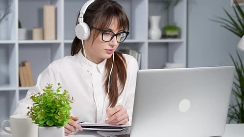 Woman Working at Laptop in Home Office