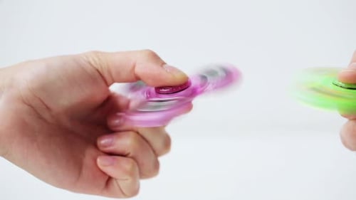 Hands Spinning Colorful Fidget Spinners Close Up