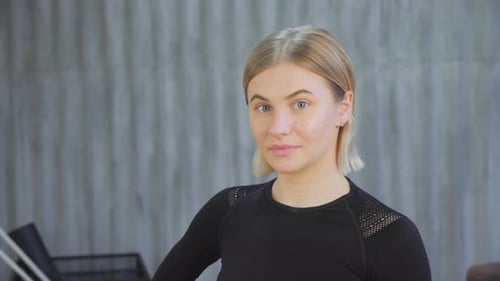Young Woman in Athletic Gear Looking at Camera