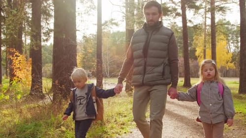 Father and Kids Enjoying Walk in Forest
