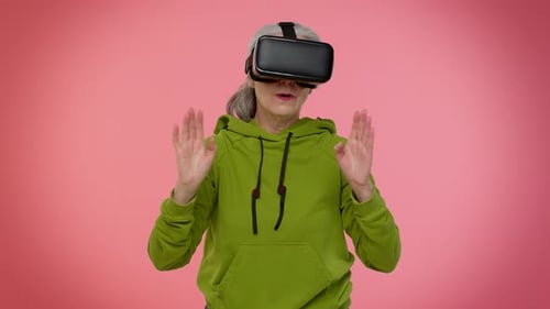 Senior Woman Exploring Virtual Reality With VR Headset