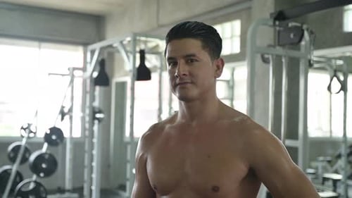 Athletic man exercises in gym fitness for strength training and bodybuilding workout