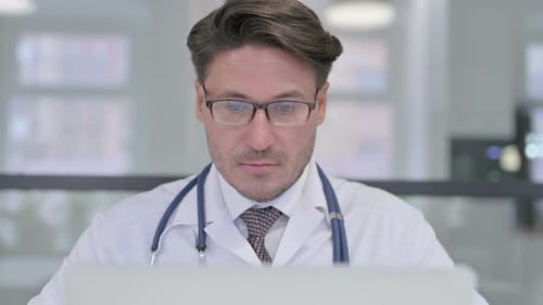 Close Up of Doctor Working on Laptop