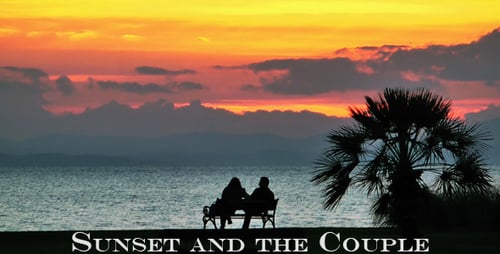 Couple on Bench Watching Beautiful Coastal Sunset