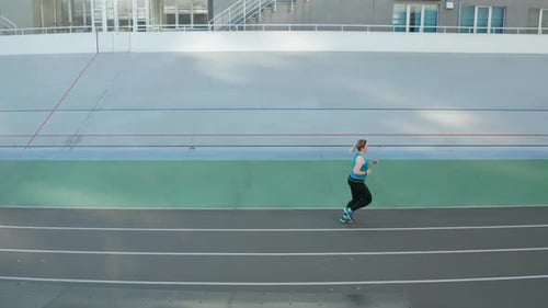 Woman Running on a Track from Above