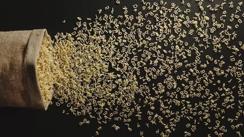 Bag falls and pasta letters are poured out of it