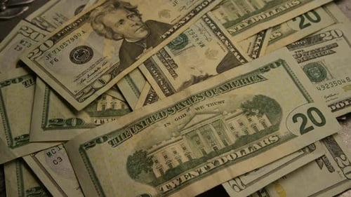 Rotating footage shot of American paper currency on an American eagle shield background