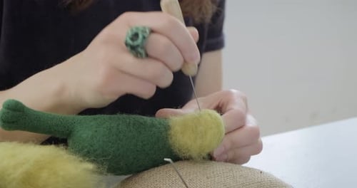 Woman Making Wool Art Doll Toy at Table Close Up. Female Sitting and Creating Ooak Doll at Home