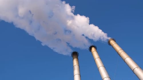 Smoke Billowing from Three Tall Chimneys